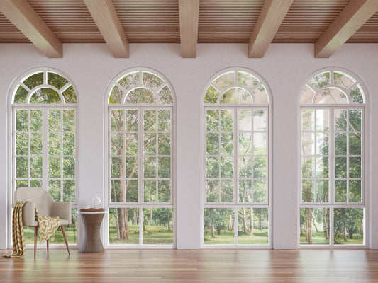 Four arched windows on a white wall with wooden ceiling