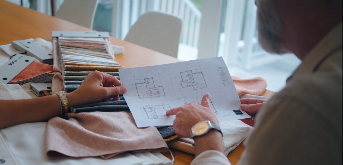 Load video: MIFU Decor team reviewing floor plans and fabrics, coordinating on-site work and supporting window covering projects.